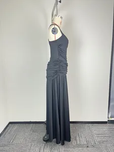 Side view of a sleeveless black maxi dress with elegant waist ruching and full skirt