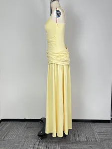 Side view of elegant yellow sleeveless maxi dress with pleated waist and long skirt
