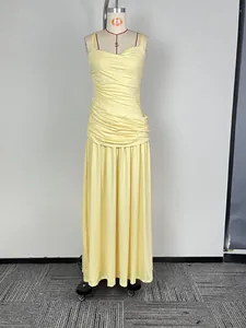 Detailed view of pale yellow sleeveless ruched maxi evening dress with pleated waist
