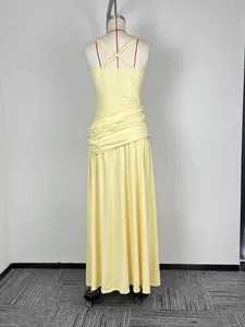 Detailed back view of a yellow sleeveless ruched maxi dress with elegant cross-straps detail