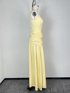 Side profile of an elegant light yellow sleeveless maxi dress featuring ruched waist details