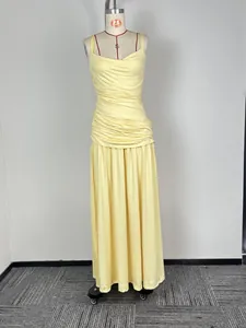 Detail view of a sleeveless ruched light yellow maxi dress on a professional mannequin