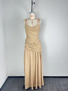 Full-length detail of a beige sleeveless ruched maxi dress featuring a flowing hemline