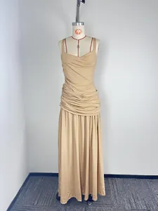 Nude sleeveless draped maxi dress with ruched waist and long flowing elegant skirt