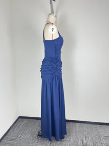 Side detail of a royal blue ruched maxi dress with thin straps and floor-length skirt