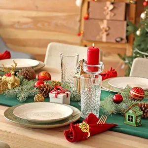 Detailed close-up view of a golden leaf napkin ring on a festive Christmas table setting.