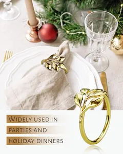 Elegant golden leaf napkin ring set used in a festive holiday dinner table setting