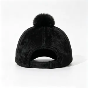 Back view of black fuzzy faux fur baseball cap with adjustable strap and pom-pom