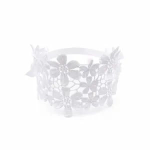 Detail of white lace floral headband for baby girls with delicate openwork pattern