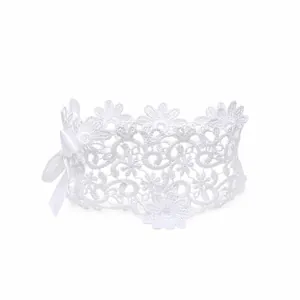 Detailed macro view of elegant white lace floral baby headband with a delicate satin bow