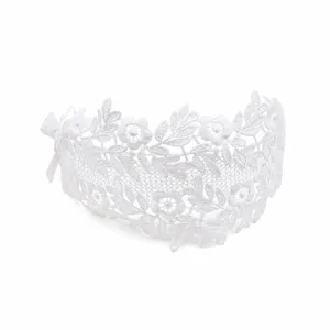Close-up of the delicate white lace floral pattern and bow detail on the baby headband