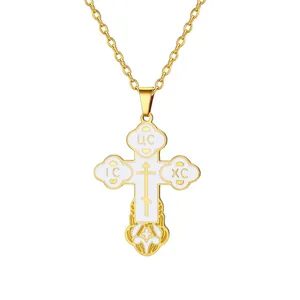 Detailed view of an Orthodox cross necklace with white enamel inlay and gold chain