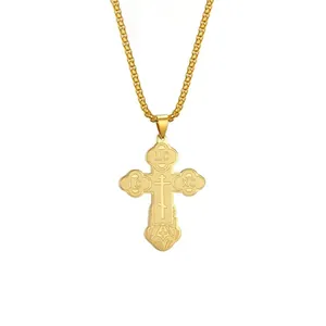 Detail view of gold-plated stainless steel cross pendant with religious engravings