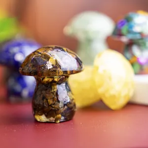 Close-up of a handmade resin mushroom figurine filled with natural tiger eye crystal stones.