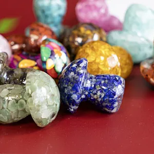 Close-up of colorful resin mushroom figurines filled with natural crushed crystals.