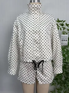 Full view of white polka dot jacket and shorts set on mannequin with stand collar