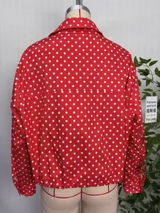 Back view of a red women's baseball jacket with white polka dots and elastic hem