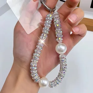 Luxury rhinestone and pearl mobile phone strap with sparkling crystal charms for women.