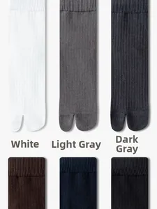 Detail view of men's ribbed cotton two-toe tabi socks in various neutral colors