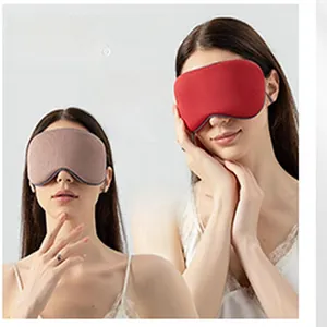 Close-up detail of dual-sided faux silk sleep masks in vibrant red and soft brown colors
