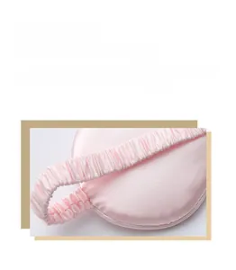 Macro view of a soft pink satin sleep mask highlighting the elastic comfort strap detail.
