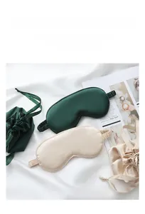 Luxury silk-like sleep mask set with matching drawstring pouches in green and beige.