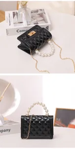 Detail view of a black quilted jelly bag with an elegant pearl handle and gold chain.