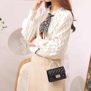 Elegant mini black jelly bag with pearl handle and quilted texture