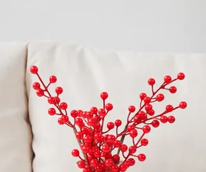 Detail of vibrant red artificial berry stems for festive floral arrangements and home decor