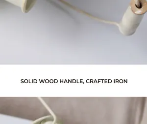 Detailed view of a vintage metal flower bucket showing wood handle and iron texture
