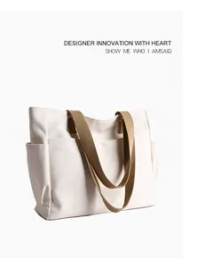 Close-up detail view of a minimalist cream canvas tote bag with robust brown straps.