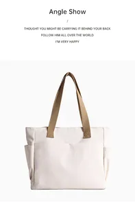 Front view of a minimalist white canvas tote bag with multiple exterior pockets and khaki straps