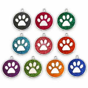A collection of ten colorful 30mm glitter paw print pet identification tags made from zinc alloy