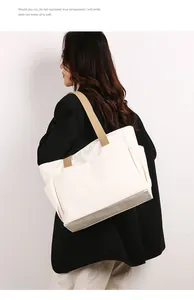Back view of a minimalist large white canvas tote bag with khaki shoulder straps
