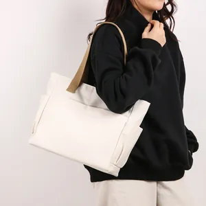 Minimalist large white canvas tote bag with durable khaki shoulder strap for women