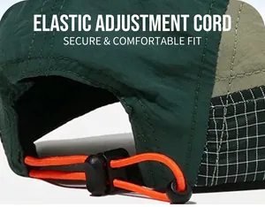 Detail of the orange elastic adjustment cord on a green quick-dry baseball cap