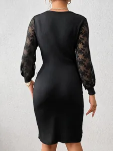 Elegant black ribbed bodycon dress with sheer floral lace sleeves, back view detail.