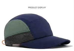 Detailed view of quick-dry five-panel cap with navy, green, and grid pattern