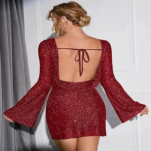 Detailed view of the backless design and sparkling sequins on a red party dress.