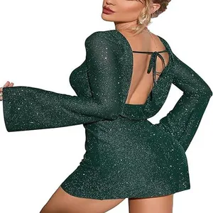 Back view detail of sparkly dark green backless mini dress with tie-up straps.