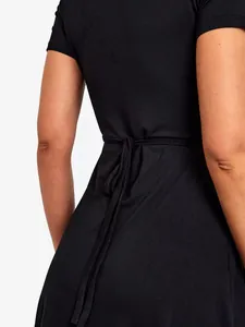 Back detail of a black maternity dress showing the waist tie and soft fabric texture.