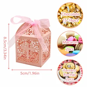 Pink laser-cut cross wedding favor candy box with ribbon and vine patterns