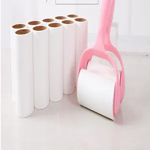 Detail of a pink lint roller with multiple white replacement refills for pet hair removal.