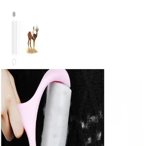 Macro shot of a pink lint roller cleaning lint off a black knitted sweater