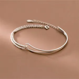 Elegant double-layer silver bracelet featuring an asymmetric starry sky chain and curved bar