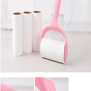 Detail view showing a pink sticky lint roller and several replacement paper rolls