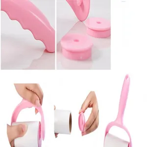Pink lint roller detail view showing ergonomic handle and sticky paper roll replacement
