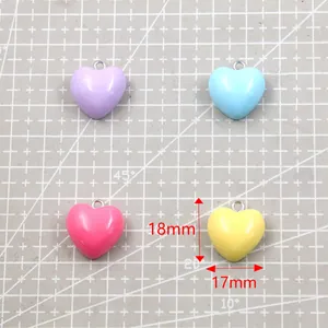 Detailed view of 17x18mm heart-shaped resin pendants in various pastel colors.