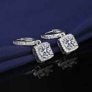 Close-up of square halo drop earrings with sparkling moissanite simulant stones