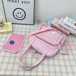 Detailed view of pink transparent ita bag with mesh insert and accessories